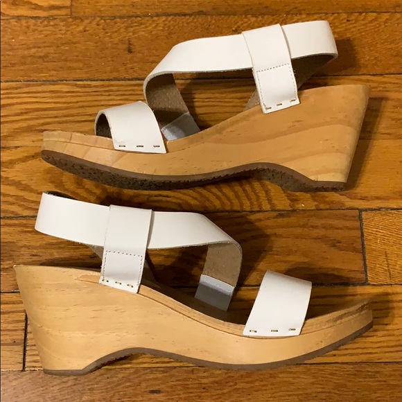 white wooden clogs
